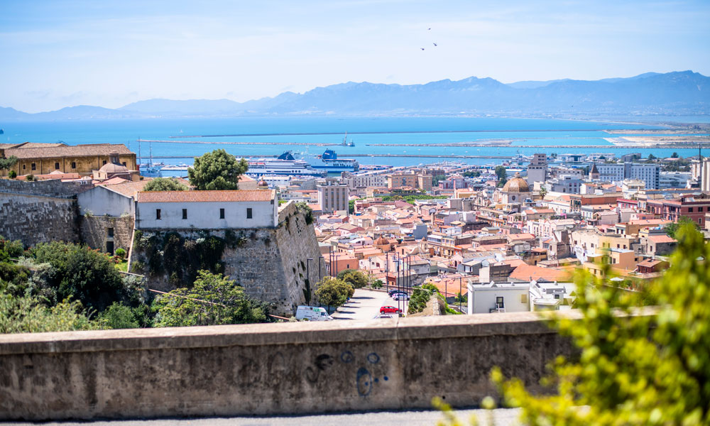 Looking out on the rooftops of Cagliari with the sea and mountains behind