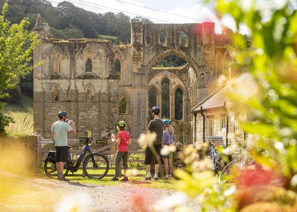 Cyclists at Rievaulx Abbey in North Yorkshire, England