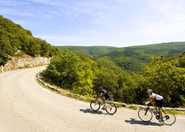 Two road cyclists riding in Dordogne, France