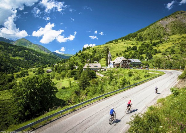 Road cyclists ascending a mountain road in the French Alps