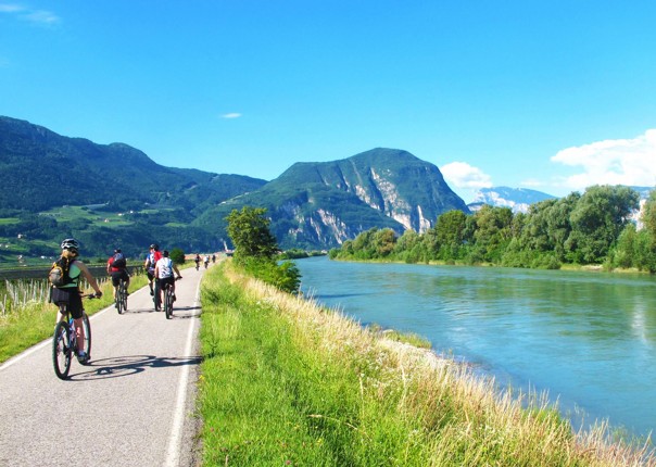 Group of cyclists on a cycle path along the Adige River in Northern Italy