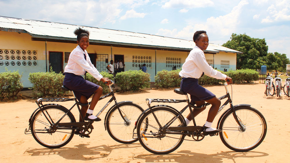 Two girls riding a Buffalo Bicycle to school