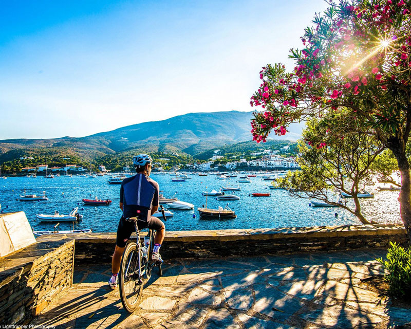 A cyclist looks out at the ocean